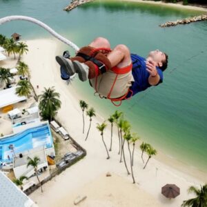 strapped to your legs, the sentosa island bungee jump is supervised by the top professional in the area - the aj hackett company