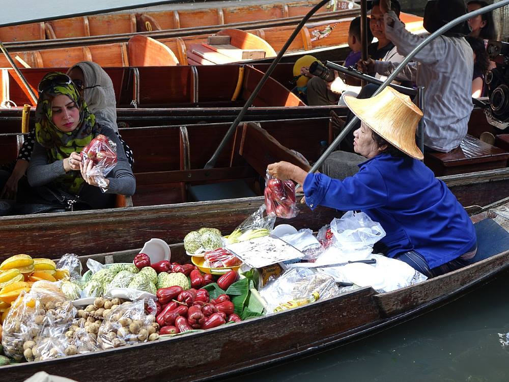 fruits to crafts are sold from a boat in the floating market of thailand