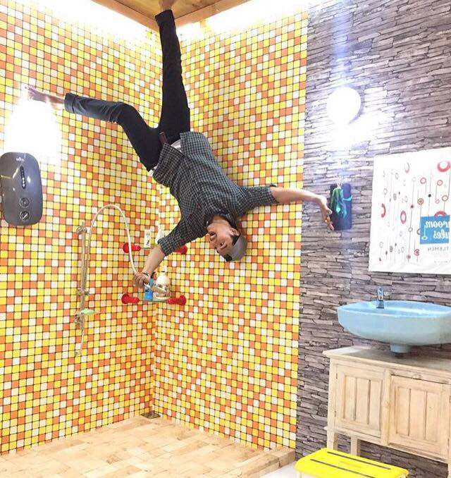 posing in the upside down house in bali indonesia