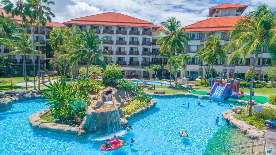 the magellan sutera resort sabah has a huge swimming pool that feels like a mini tropical paradise